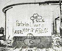 Patria Libre o Morir (Free Country or Death) – Graffiti on the side of a bombed-out building in Managua, Nicaragua, 1979. A scribbled drawing of Sandino’s hat floats above the letters, F.S.L.N. (Sandinista National Liberation Front), the revolutionaries who overthrew the dictatorship of Anastasio Somoza in 1979. Photo taken by Koen Wessing.