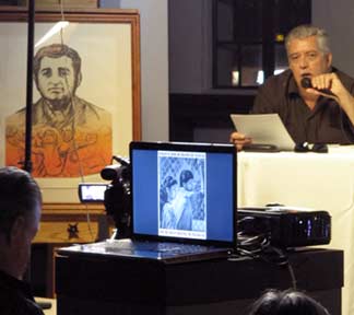This writer presenting the story behind the poster of Ruben Salazar by Siqueiros. Photo by Jeannine Thorpe ©