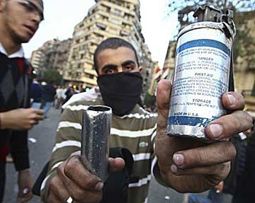 Anti-Mubarak demonstrators in the streets of Cairo display empty tear-gas canisters clearly labeled, "Made in the U.S.A." Anonymous photo courtesy of imgur.com