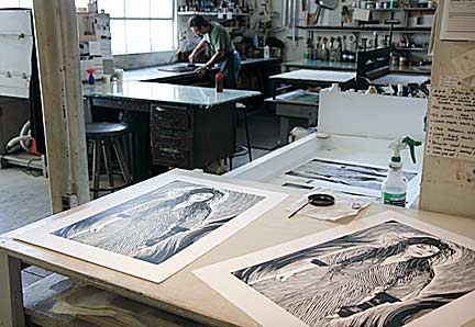 As Greco re-inks the linoleum block for printing, wet prints "hot off the press" can be seen drying in the foreground. Photograph by Mark Vallen ©