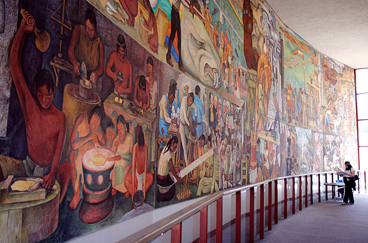 This photo captures the immensity of Rivera's Pan American Unity mural, but the perspective still does not show the entire work. Measuring 22 feet high by 74 feet long, the fresco mural is painted on 10 steel-framed panels that were bolted together, allowing the entire painting to be dismantled and moved. Altogether the massive painting weighs 23 tons. Photograph by Mark Vallen ©