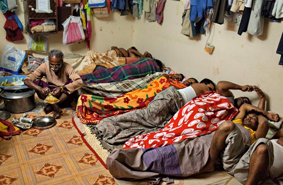 Guest workers from Uttar Pradesh, India, crammed into their sleeping quarters in Dubai, UAE. The photo comes from the January 2014 National Geographic article, "The Lives Of Guest Workers." Photo by Jonas Bendiksen.
