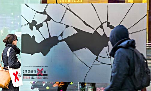 An enormous sticker simulating broken glass in a shop window in Berlin, Nov. 8, 2013. The stickers were part of a campaign mounted by the German History Museum in Berlin to commemorate "Kristallnacht." Photo/Reuters. An enormous sticker simulating broken glass in a shop window in Berlin, Nov. 8, 2013. The stickers were part of a campaign mounted by the German History Museum in Berlin to commemorate "Kristallnacht." Photo/Reuters.
