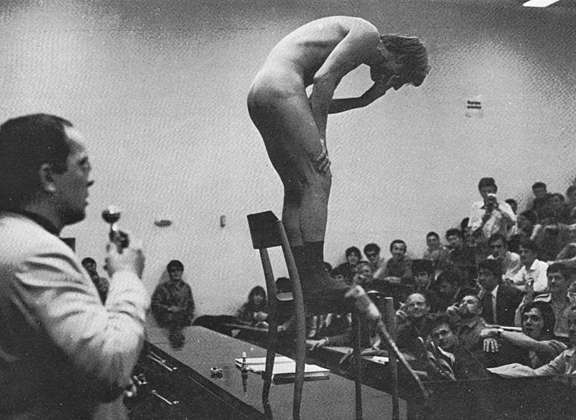 Günter Brus vomits during an unauthorized actionist performance of Art and Revolution at the University of Vienna, 1968. 