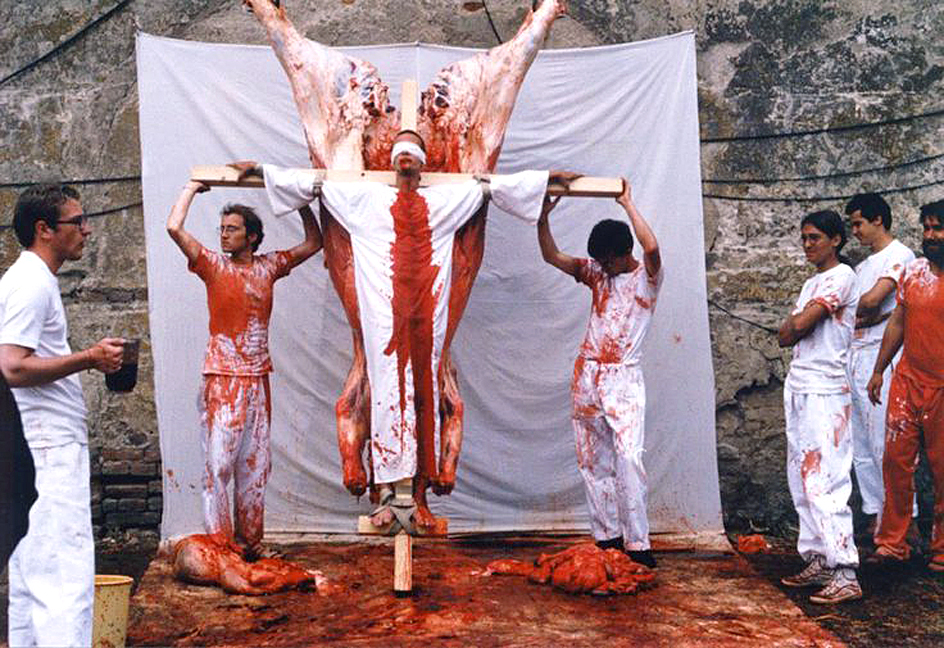 Hermann Nitsch performance, date, place, and photographer unknown. In this photo assistants use cow, lamb, and pig entrails and blood.