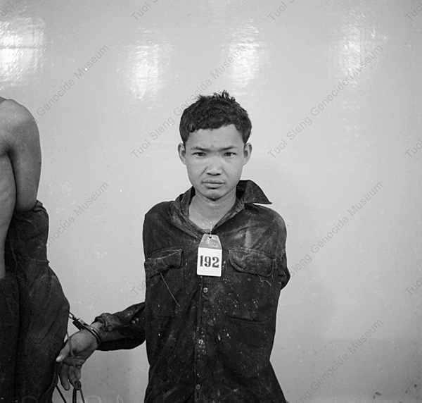 Unidentified men in Security Prison 21 are bound with rope and shackled together. Photo: Tuoi Sleng Genocide Museum.