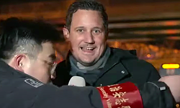 Screen grab from video showing Dutch reporter at Beijing Olympics dragged away by communist security. 