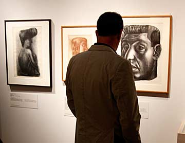 At the Opening Reception for Censorship Defied at the Autry National Center, a member views lithographs by Siqueiros. Photo by Mark Vallen ©