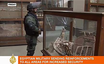 Pro-Democracy demonstrators rushed to protect the Egyptian Museum; they are pictured here guarding the museum entry gate in a still from a video by Euronews. Photo courtesy of AFP