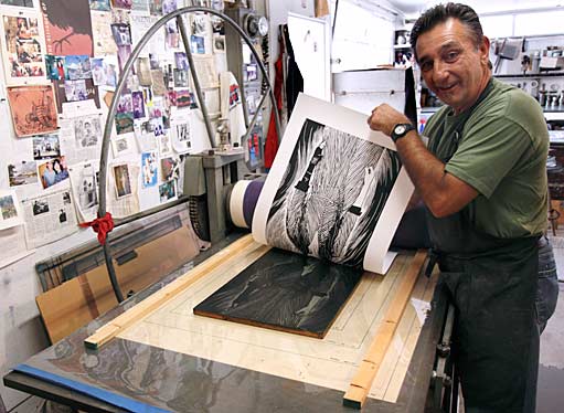 Greco reveals the very first print to come off the press. Photograph by Mark Vallen ©