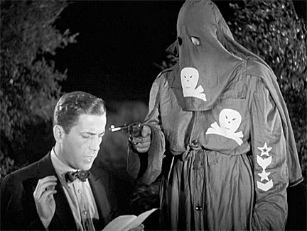  Still from the 1937 Warner Bros. film, "Black Legion", starring Humphrey Bogart. In this photo Bogart's "Frank Taylor" character takes the terror group's oath.