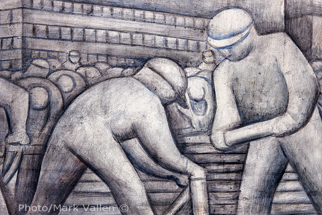 In this detail from the north wall fresco, workers are shown cutting and stacking steal bars.