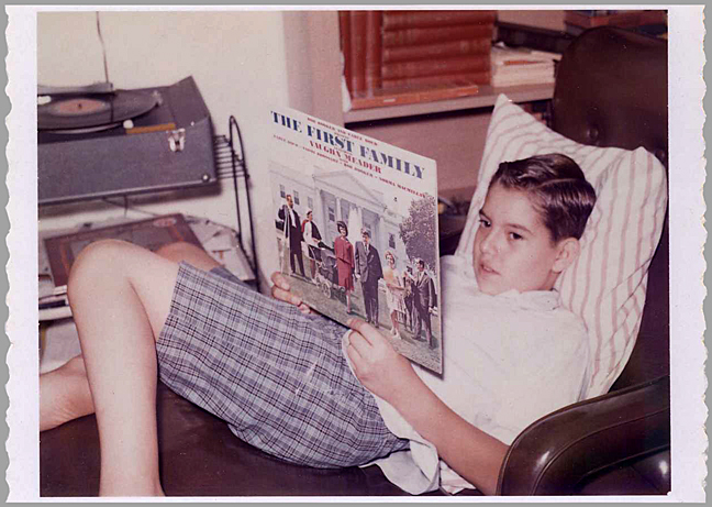 The comedy album The First Family, was one of the most popular records in the United States in 1962. A lighthearted parody of President Kennedy and his family, the album was recorded on the very evening that J.F.K. made his Cuban Missile Crisis speech. The album sold nearly eight million copies, more than the debut album of Peter, Paul, and Mary. I bought the album as soon as it was released, and in the above photo I am pictured listening to it on my portable record player. Photo by the artist's father, Joe Vallen.