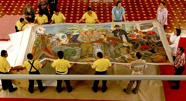 Museum staff from Guatemala's National Palace of Culture, and experts from Russia's Puskin Museum, uncrate Rivera's painting in preparation for the exhibit "Oh Revolution! 1944-2010 Multiple Visions," held in Guatemala's capital in 2010. Photo by Paulo Raquec for the Government of Guatemala.