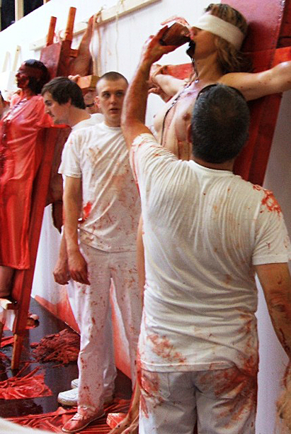Hermann Nitsch was a premier guest at the 2009 Incubate arts festival in Tilburg, Netherlands. In this photo assistants undergoing mock crucifixions drink and bath in animal blood.